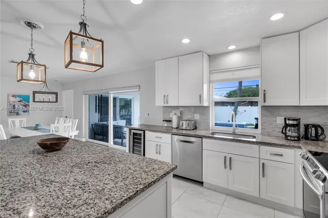 a kitchen with a stove a sink and cabinets