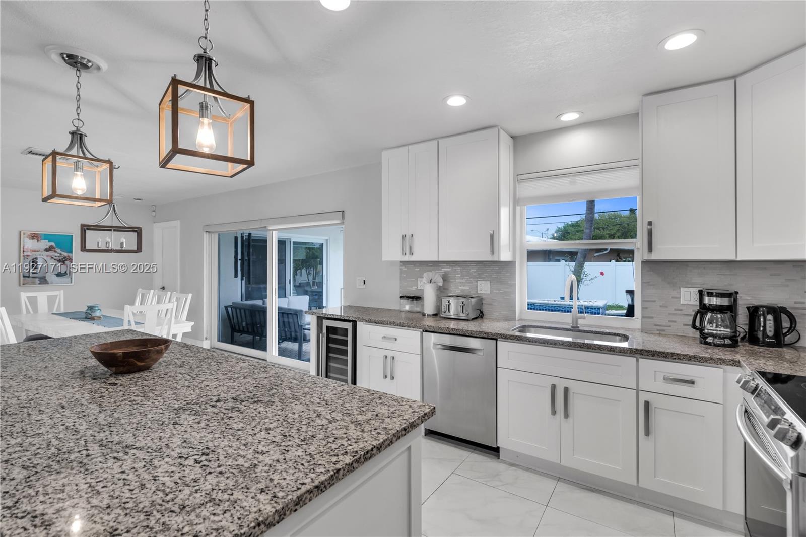 251 Southeast 8th Street Pompano Beach, FL 33060 - Photo 8 of 34 a kitchen with a stove a sink and cabinets