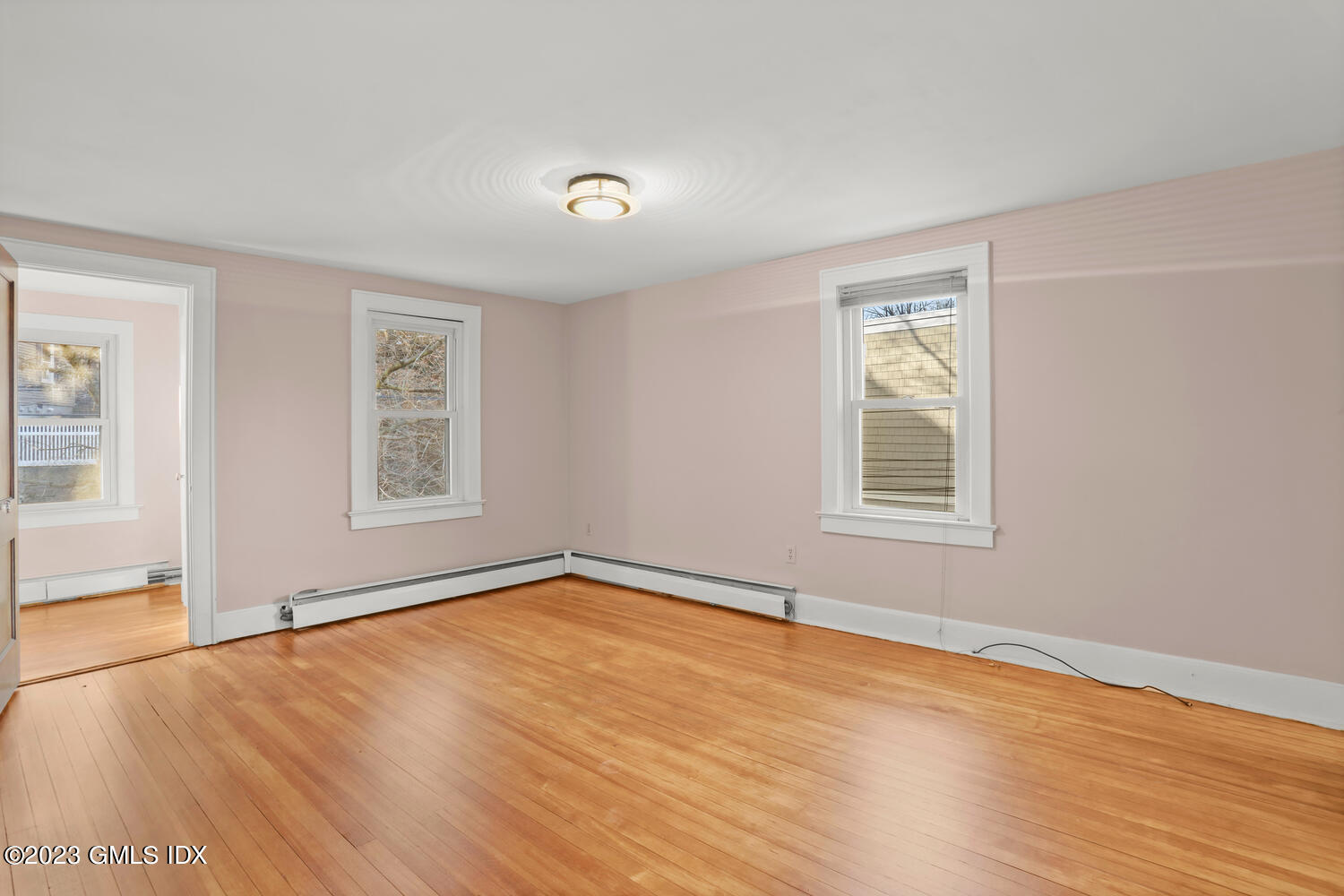 175 Davis Avenue Greenwich, CT 06830 - Photo 12 of 27 a view of an empty room with wooden floor and a window
