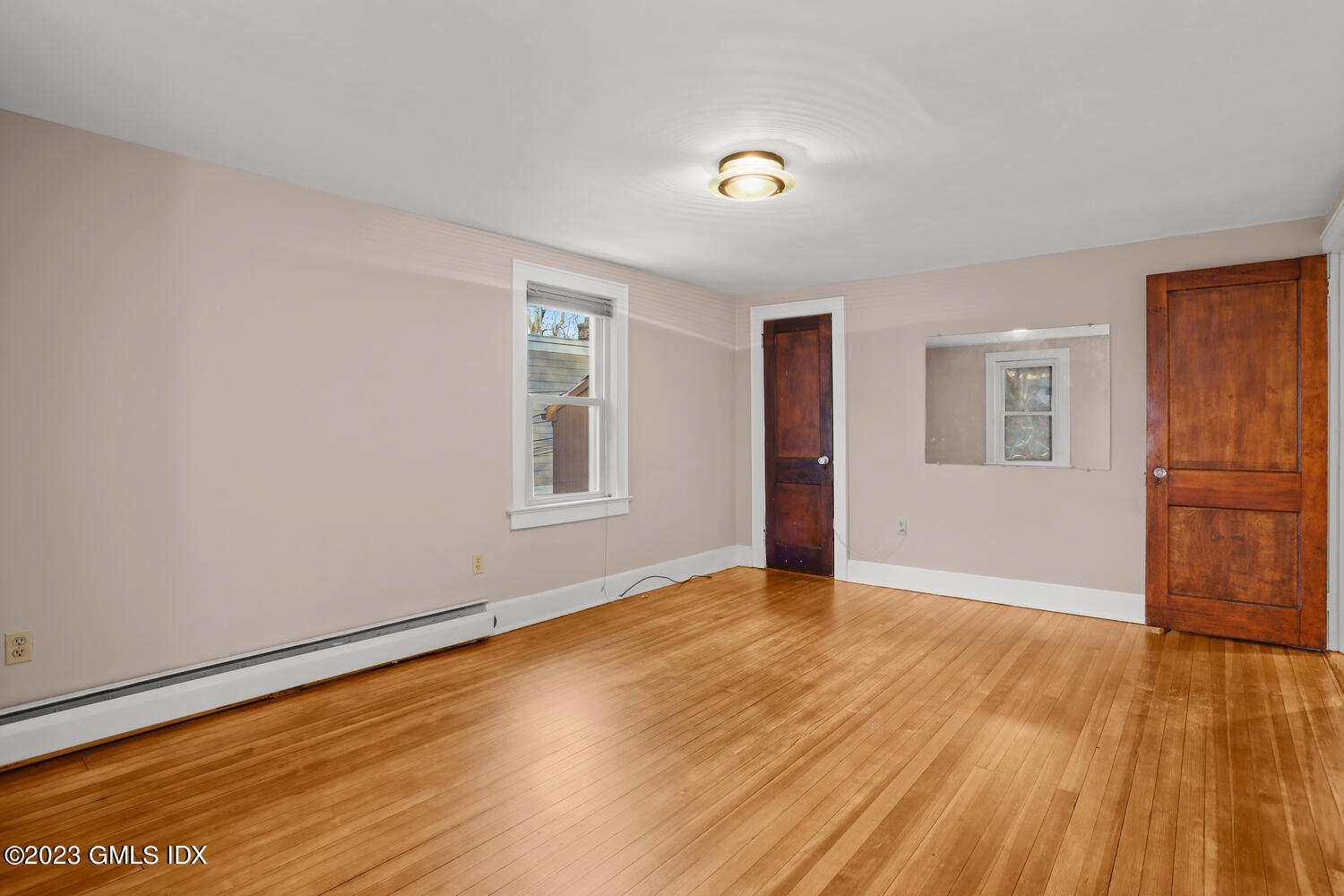 175 Davis Avenue Greenwich, CT 06830 - Photo 13 of 27 an empty room with wooden floor and windows