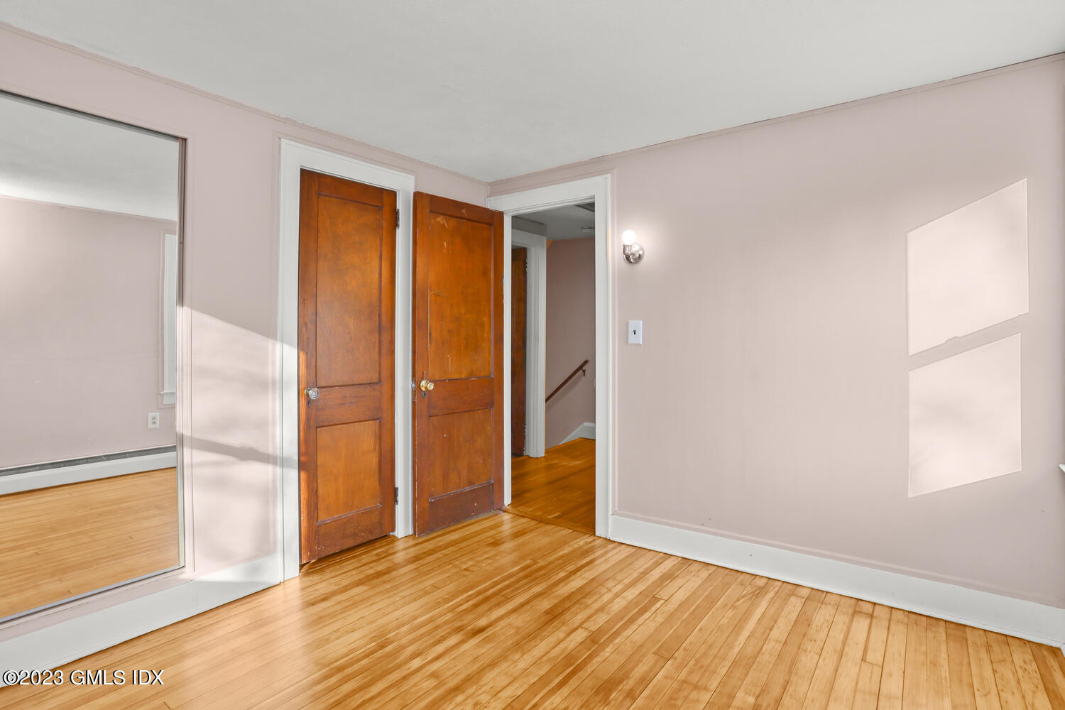 175 Davis Avenue Greenwich, CT 06830 - Photo 17 of 27 an empty room with wooden floor and a window