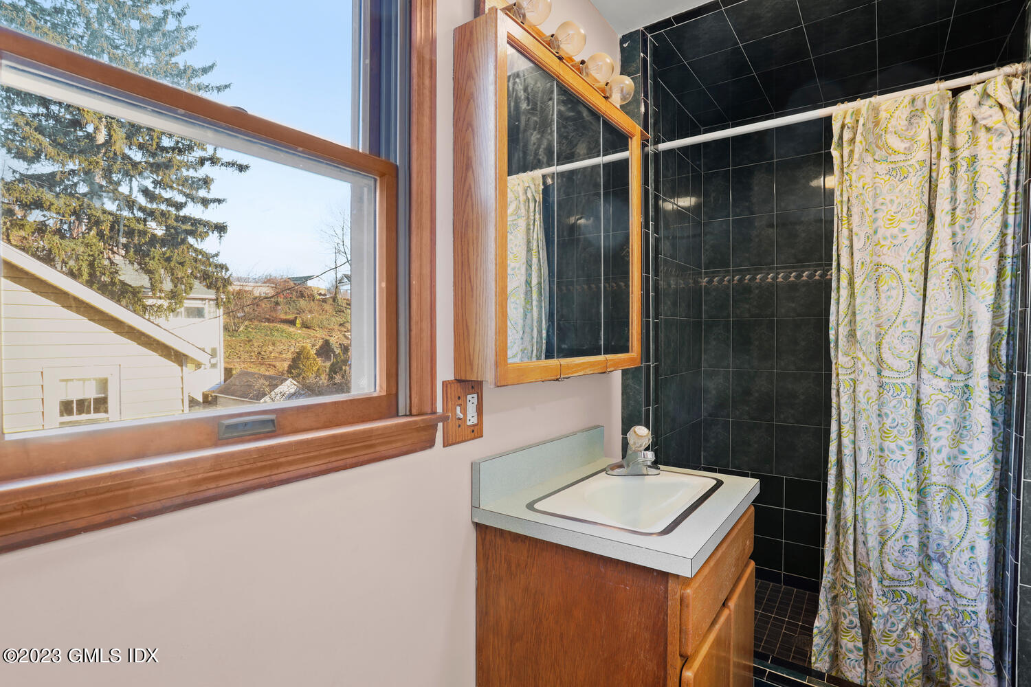 175 Davis Avenue Greenwich, CT 06830 - Photo 19 of 27 a bathroom with a sink mirror and a shower
