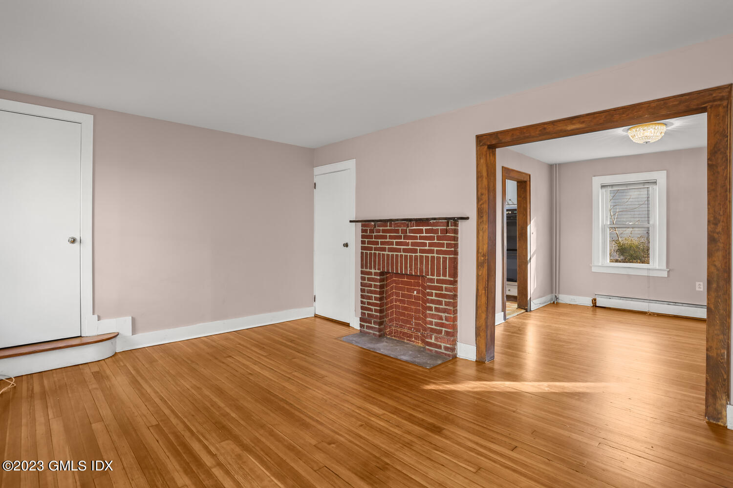 175 Davis Avenue Greenwich, CT 06830 - Photo 3 of 27 an empty room with wooden floor and windows