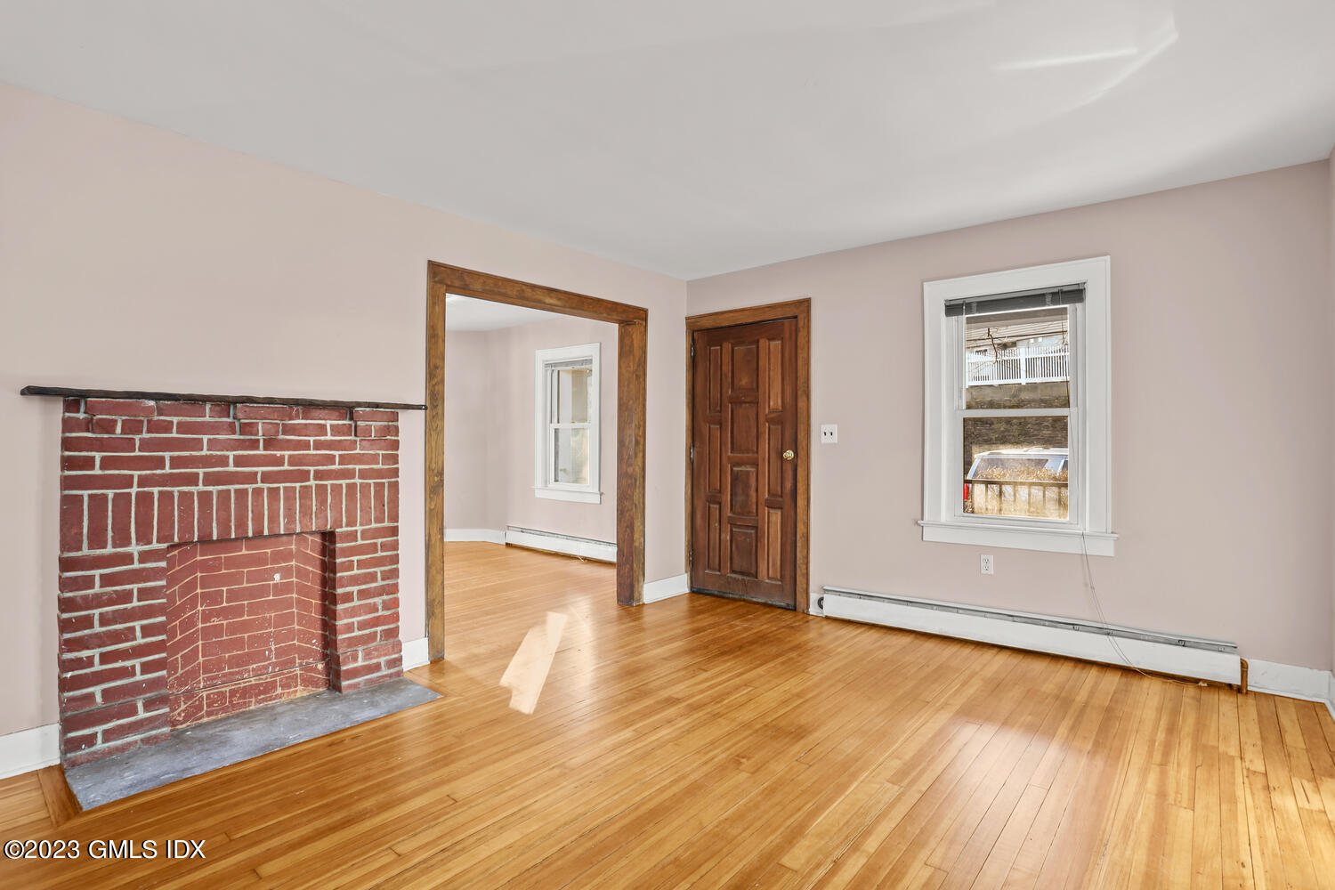 175 Davis Avenue Greenwich, CT 06830 - Photo 4 of 27 a view of an empty room with wooden floor and a window