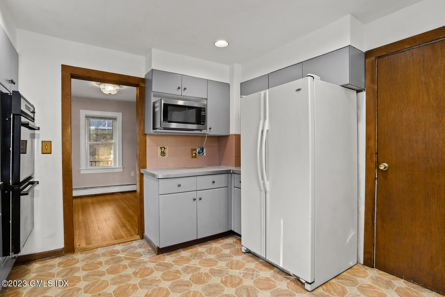 175 Davis Avenue Greenwich, CT 06830 - Photo 8 of 27 a room with a refrigerator and a television