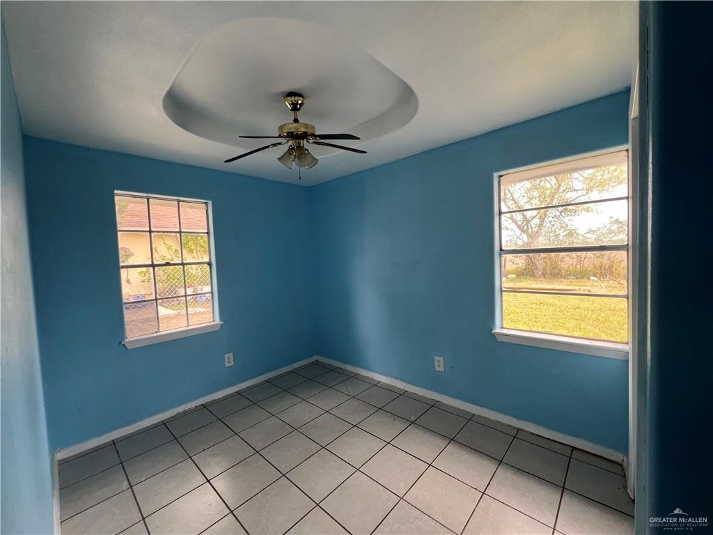 1015 Martinez Street Weslaco, TX 78596 - Photo 6 of 10 Spare room with a ceiling fan and light tile patterned floors