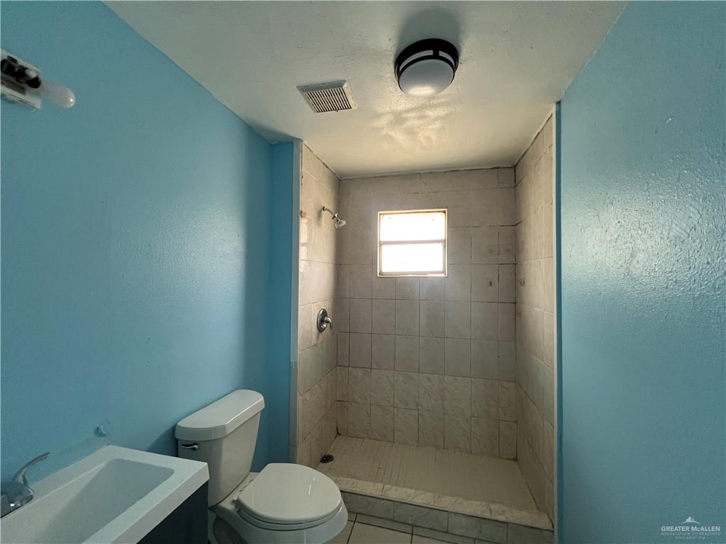 1015 Martinez Street Weslaco, TX 78596 - Photo 7 of 10 Bathroom with vanity and a shower stall