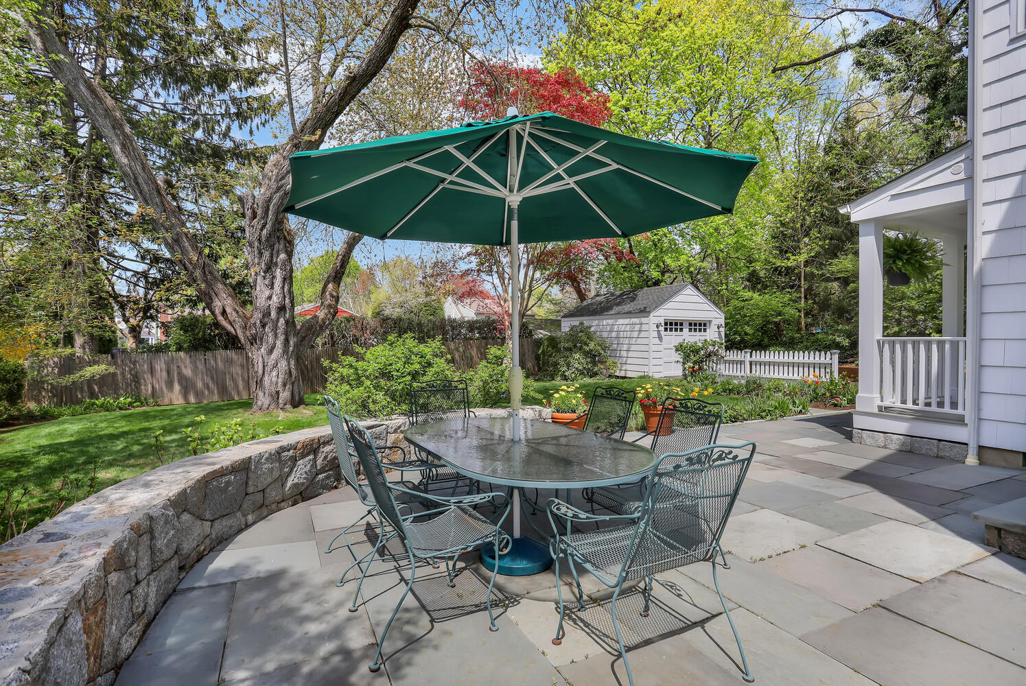 3 Dickinson Road Darien, CT 06820 - Photo 20 of 30 a view of patio with chairs and table under an umbrella