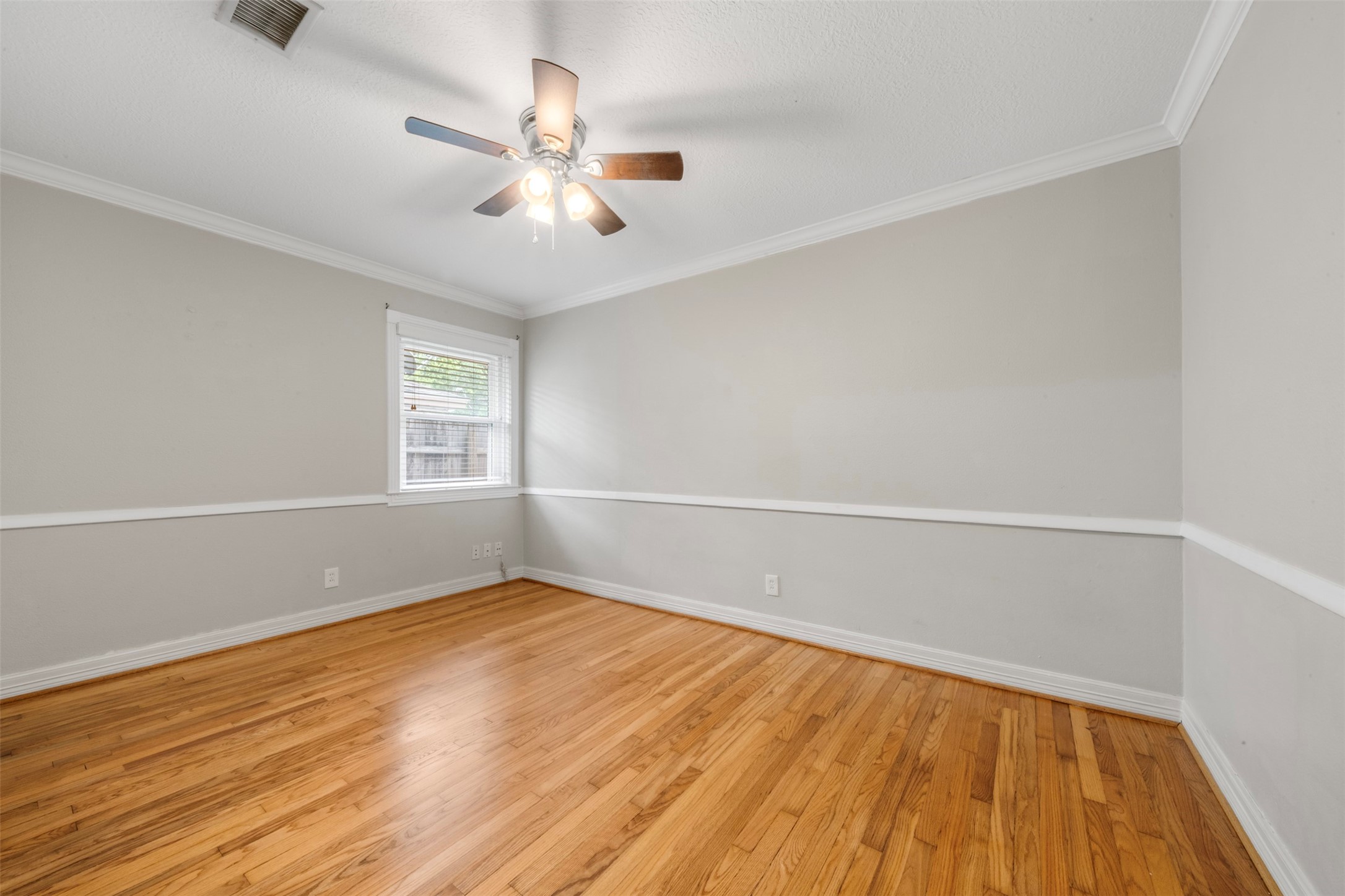 4307 Spellman Road Houston, TX 77035 - Photo 17 of 31 Bedroom 1 with polished wood floors, fresh paint and chair rail.