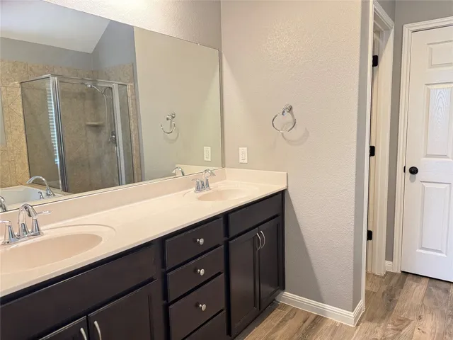 a bathroom with a double vanity sink and mirror