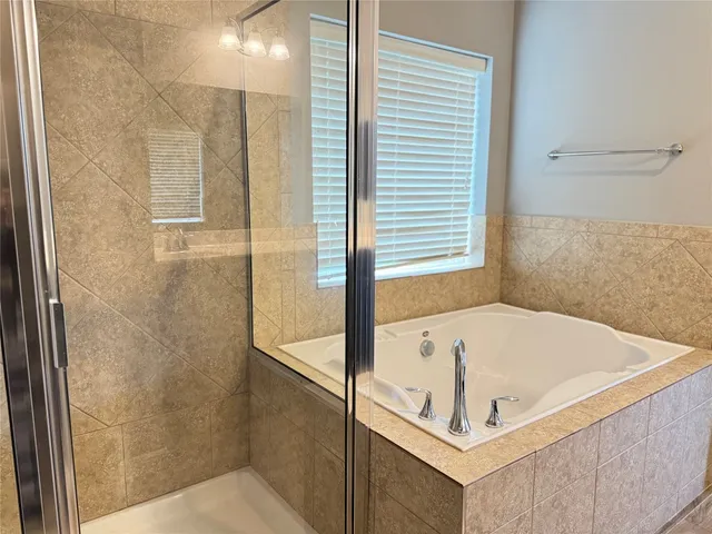 a bathroom with a tub and shower