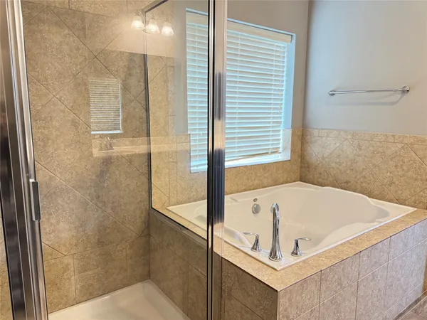 a bathroom with a tub and shower