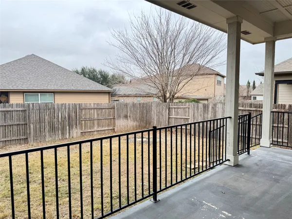 a view of balcony with wooden fence