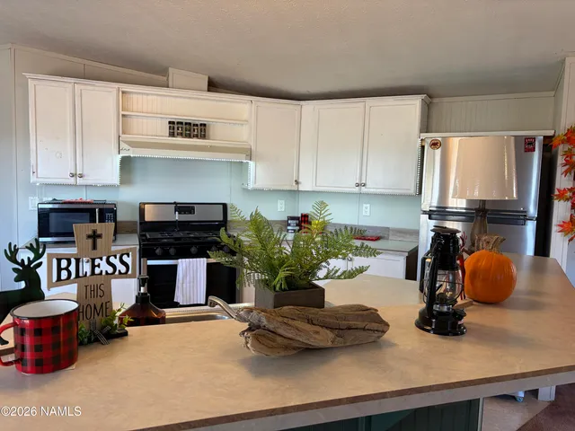 a bedroom with a bed and a potted plant