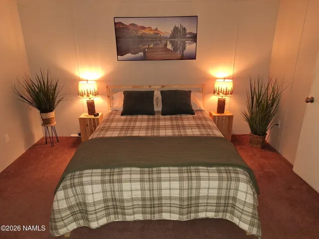 a view of a house with backyard and trees