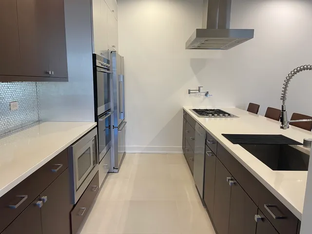 a kitchen with a sink stove and refrigerator