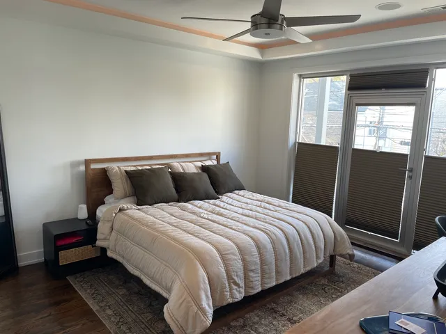 a bedroom with bed and window