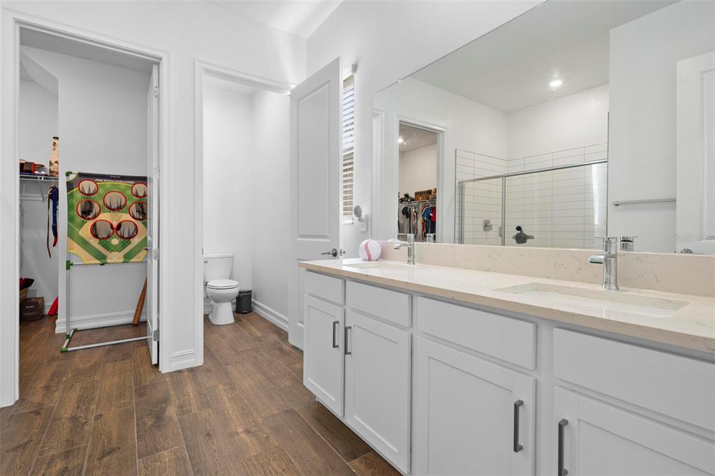 4898 Southern Valley Loop Brooksville, FL 34601 - Photo 16 of 81 a bathroom with a double vanity sink and a mirror