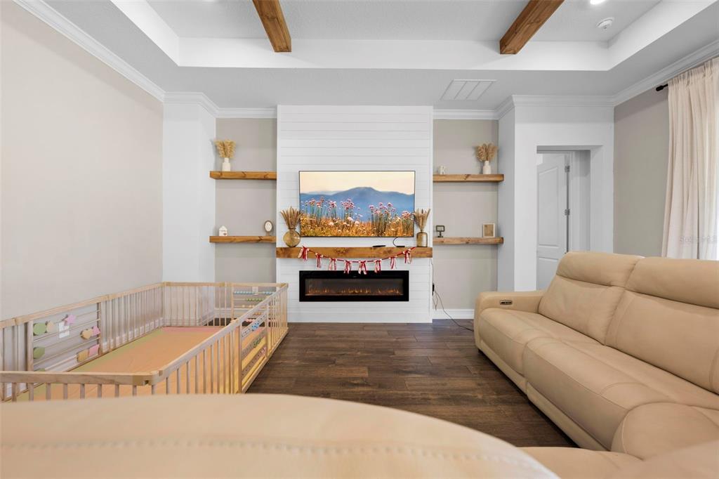4898 Southern Valley Loop Brooksville, FL 34601 - Photo 23 of 81 a living room with a couch a fireplace and a large window