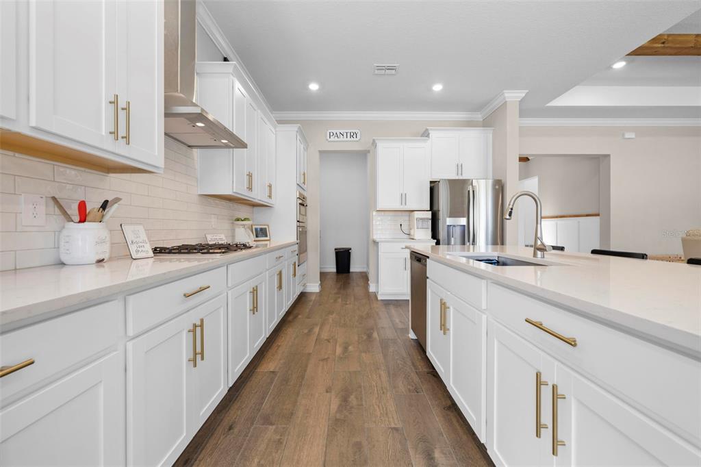 4898 Southern Valley Loop Brooksville, FL 34601 - Photo 34 of 81 a large kitchen with cabinets and wooden floor