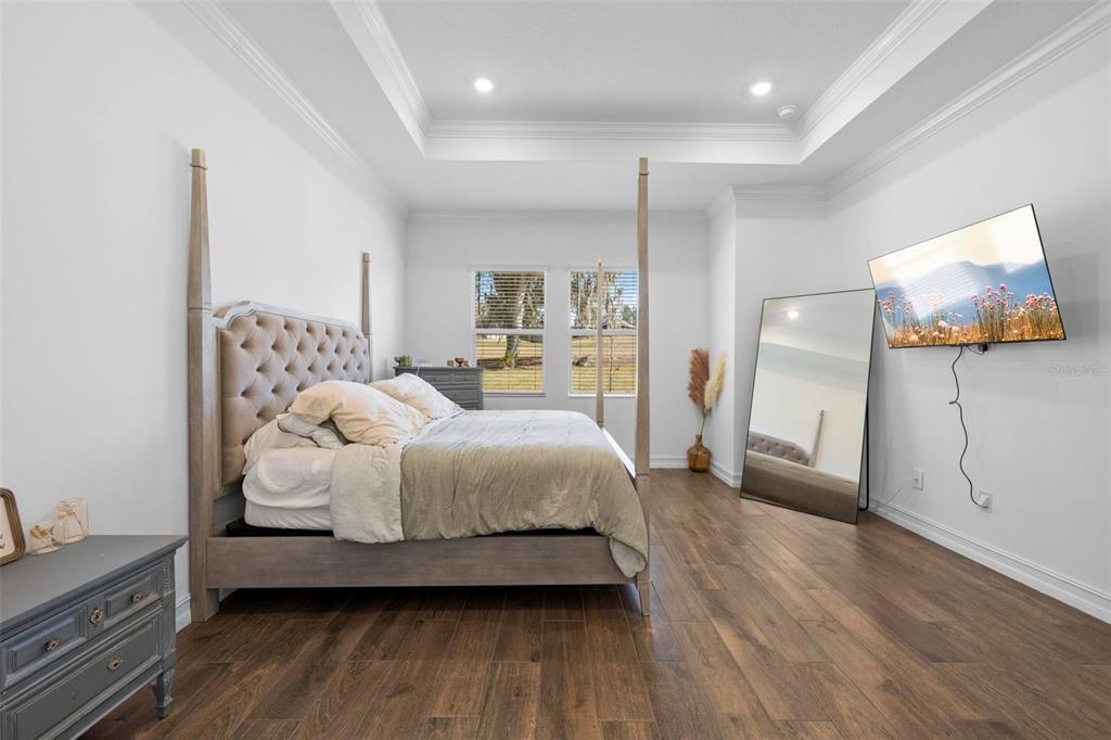 4898 Southern Valley Loop Brooksville, FL 34601 - Photo 43 of 81 a bedroom with a bed and wooden floor