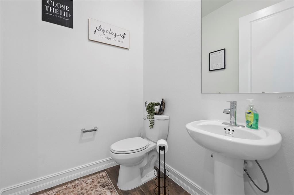 4898 Southern Valley Loop Brooksville, FL 34601 - Photo 51 of 81 a white toilet sitting next to a bathroom sink