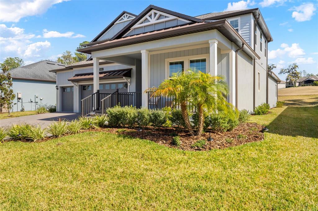 4898 Southern Valley Loop Brooksville, FL 34601 - Photo 72 of 81 a view of a house with a small yard plants and large tree