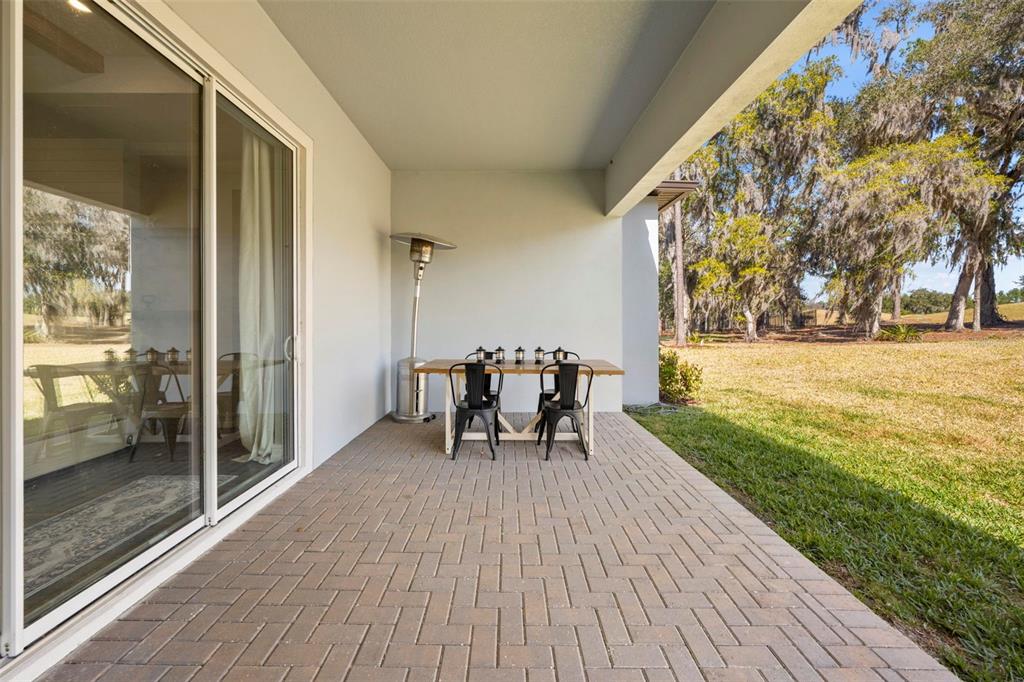4898 Southern Valley Loop Brooksville, FL 34601 - Photo 77 of 81 a view of a patio with a table and chairs and garden