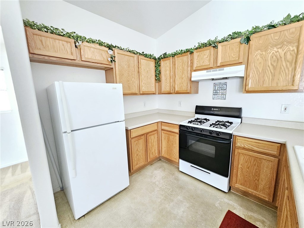 1663 Lefty Garcia Way Henderson, NV 89002 - Photo 17 of 31 A well-appointed kitchen features ample cabinetry and essential appliances, ready for culinary endeavors.