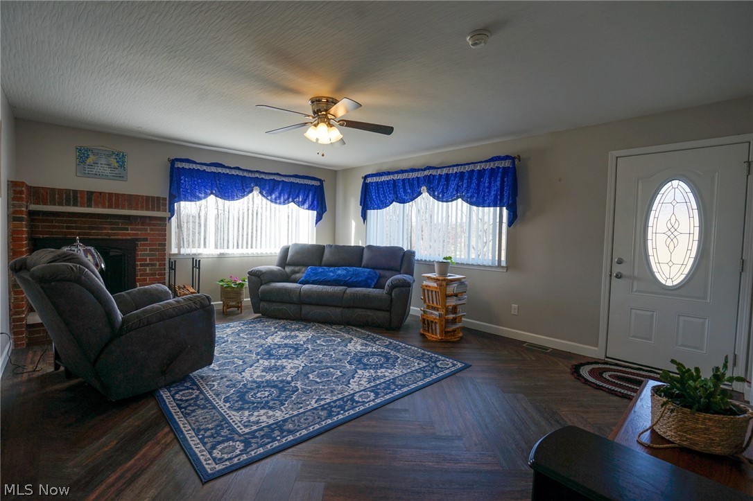 1325 County Line Road Hopewell, OH 43746 - Photo 10 of 45 Living room featuring ceiling fan, parquet flooring, and a brick fireplace