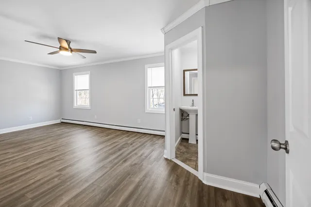 wooden floor in an empty room with a window
