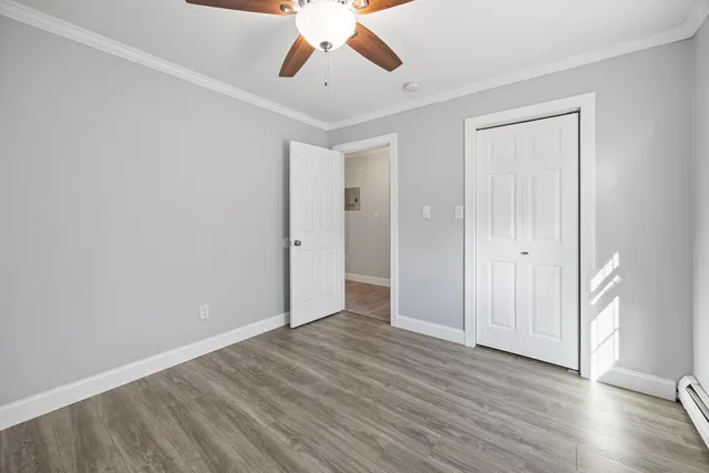 a view of an empty room and wooden floor