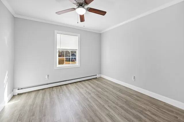 wooden floor in an empty room with a window
