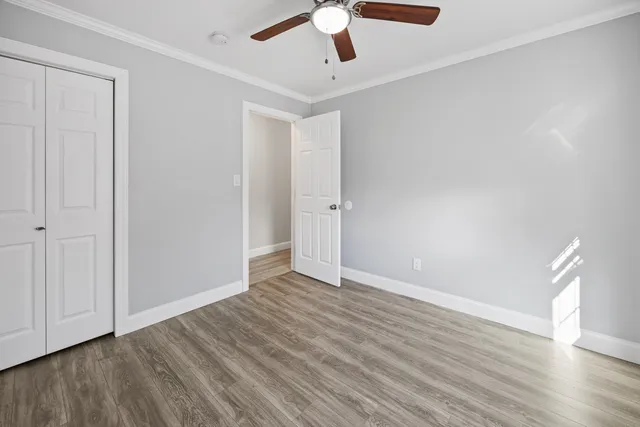 a view of an empty room with wooden floor