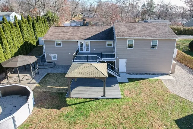 a view of a house with backyard and sitting area