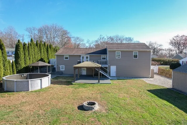 a view of a house with backyard and sitting area