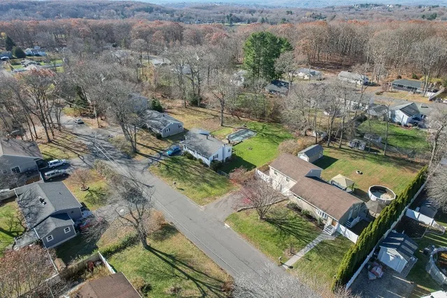 an aerial view of a house with a yard