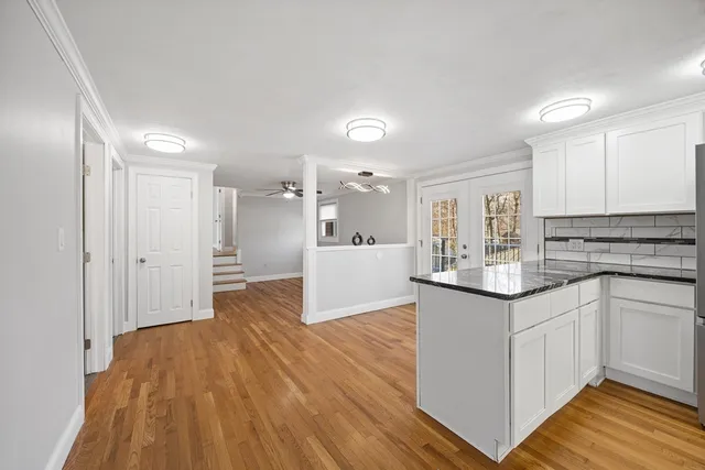 a kitchen with stainless steel appliances granite countertop a sink and cabinets