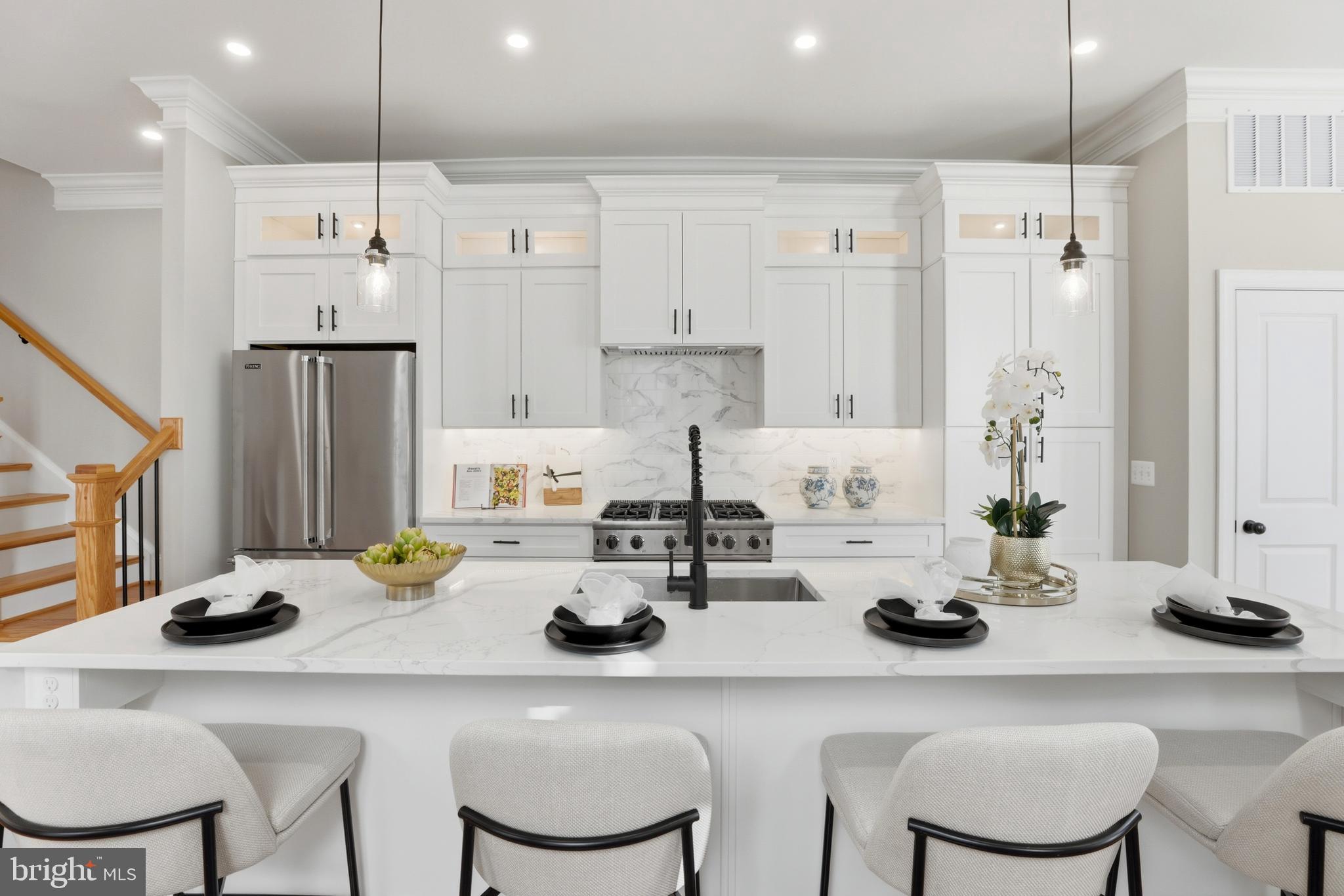 910 Westminster Street Northwest Washington, DC 20001 - Photo 13 of 66 a kitchen with a sink a stove and chairs