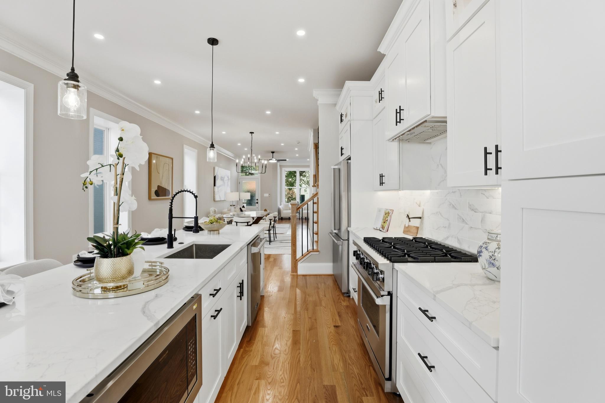 910 Westminster Street Northwest Washington, DC 20001 - Photo 14 of 66 a open kitchen with stainless steel appliances granite countertop a sink a stove and a wooden floors