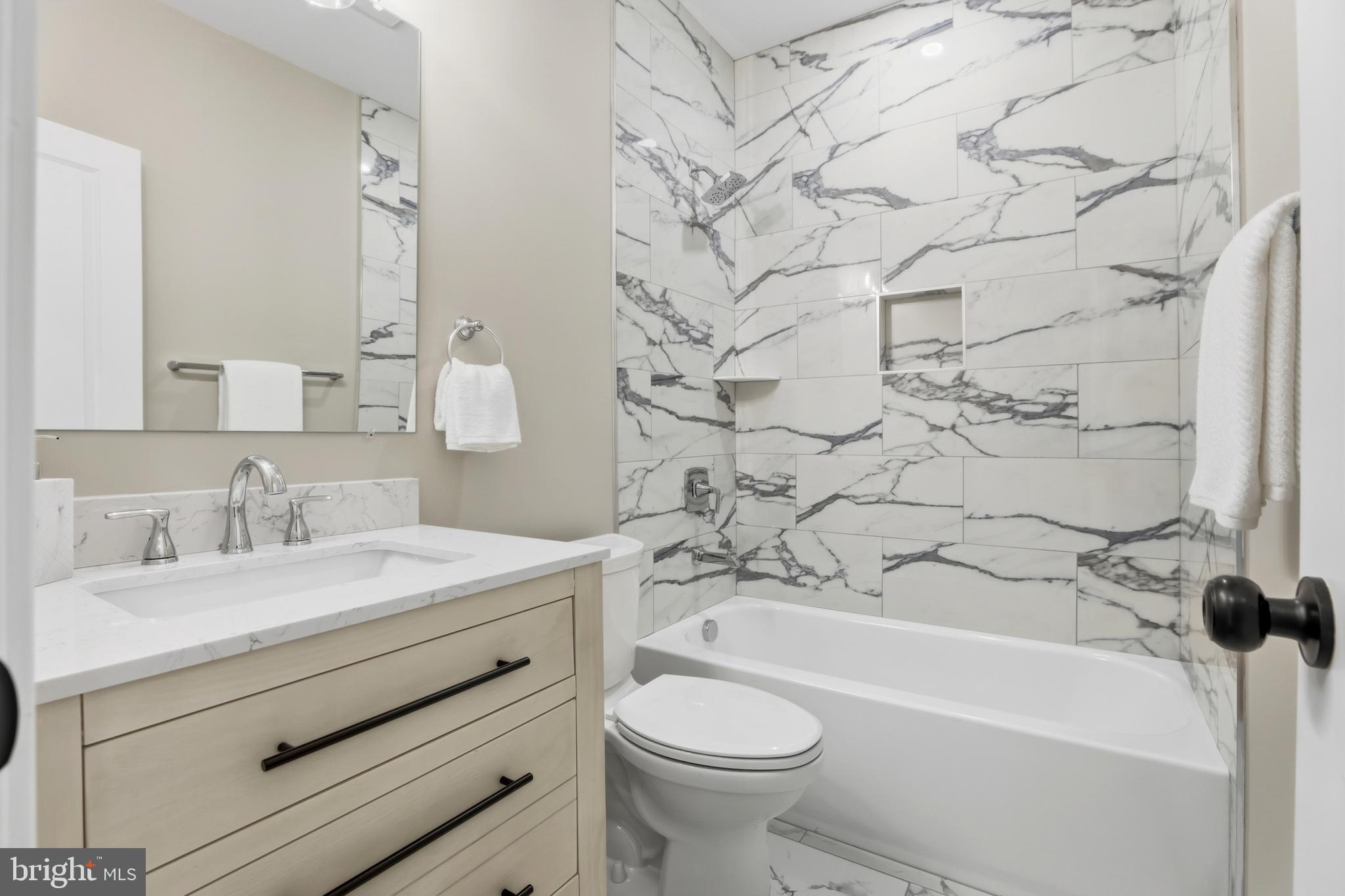 910 Westminster Street Northwest Washington, DC 20001 - Photo 26 of 66 a bathroom with a sink toilet vanity and bathtub