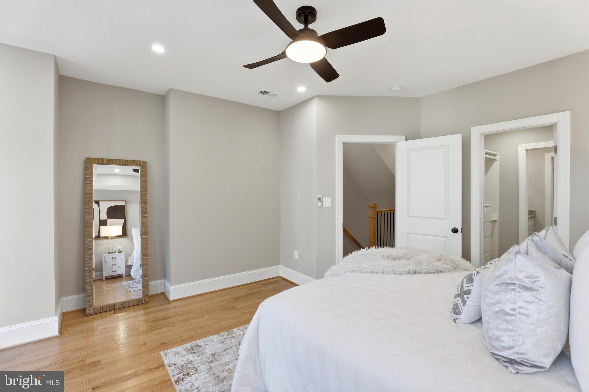 910 Westminster Street Northwest Washington, DC 20001 - Photo 29 of 66 a bedroom with a large bed and a chandelier