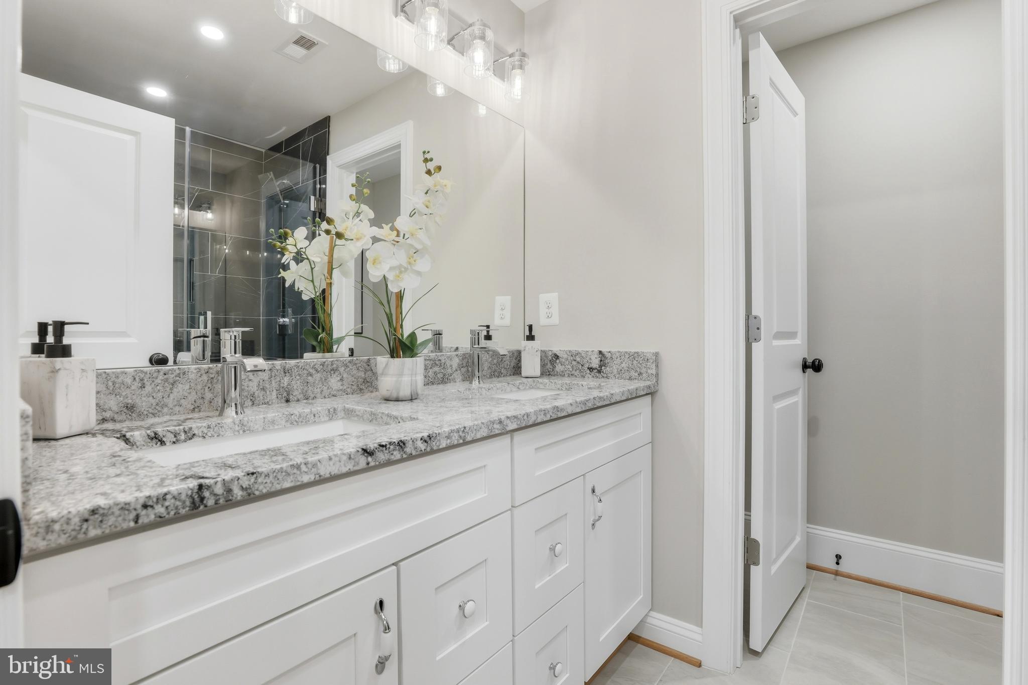 910 Westminster Street Northwest Washington, DC 20001 - Photo 35 of 66 a bathroom with a granite countertop sink and a mirror