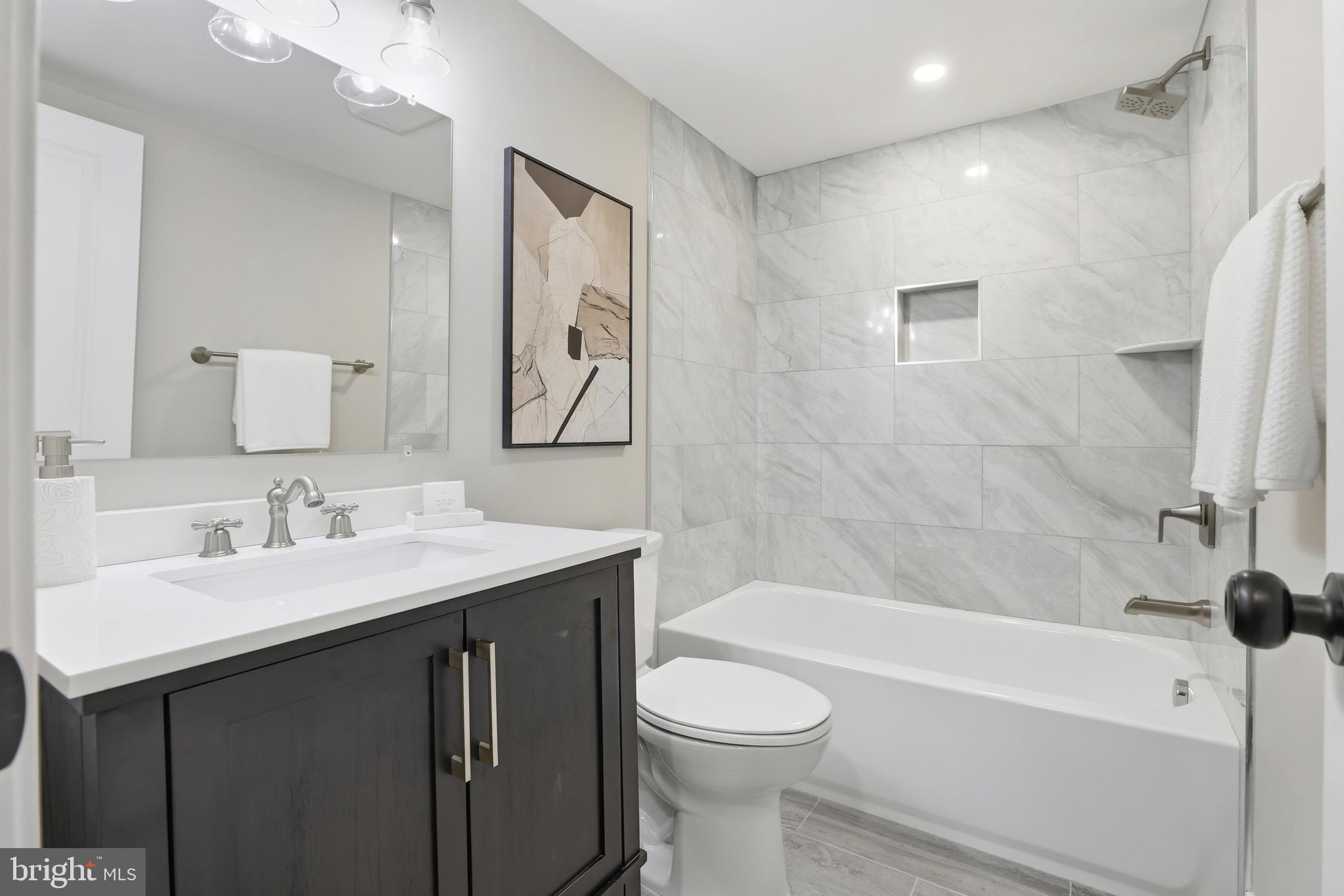 910 Westminster Street Northwest Washington, DC 20001 - Photo 41 of 66 a bathroom with a granite countertop sink toilet and shower