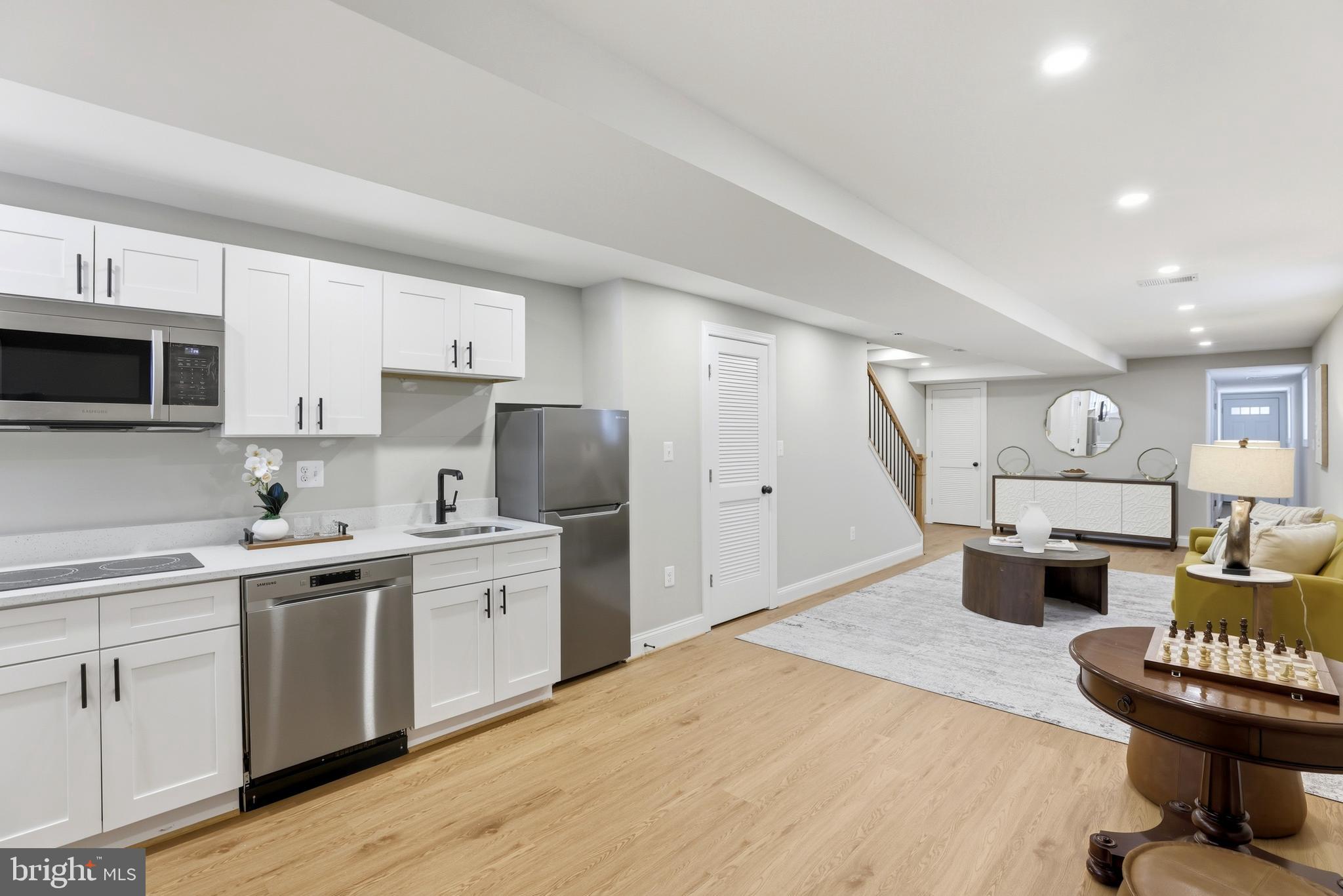 910 Westminster Street Northwest Washington, DC 20001 - Photo 45 of 66 a kitchen with a stove a sink and a refrigerator