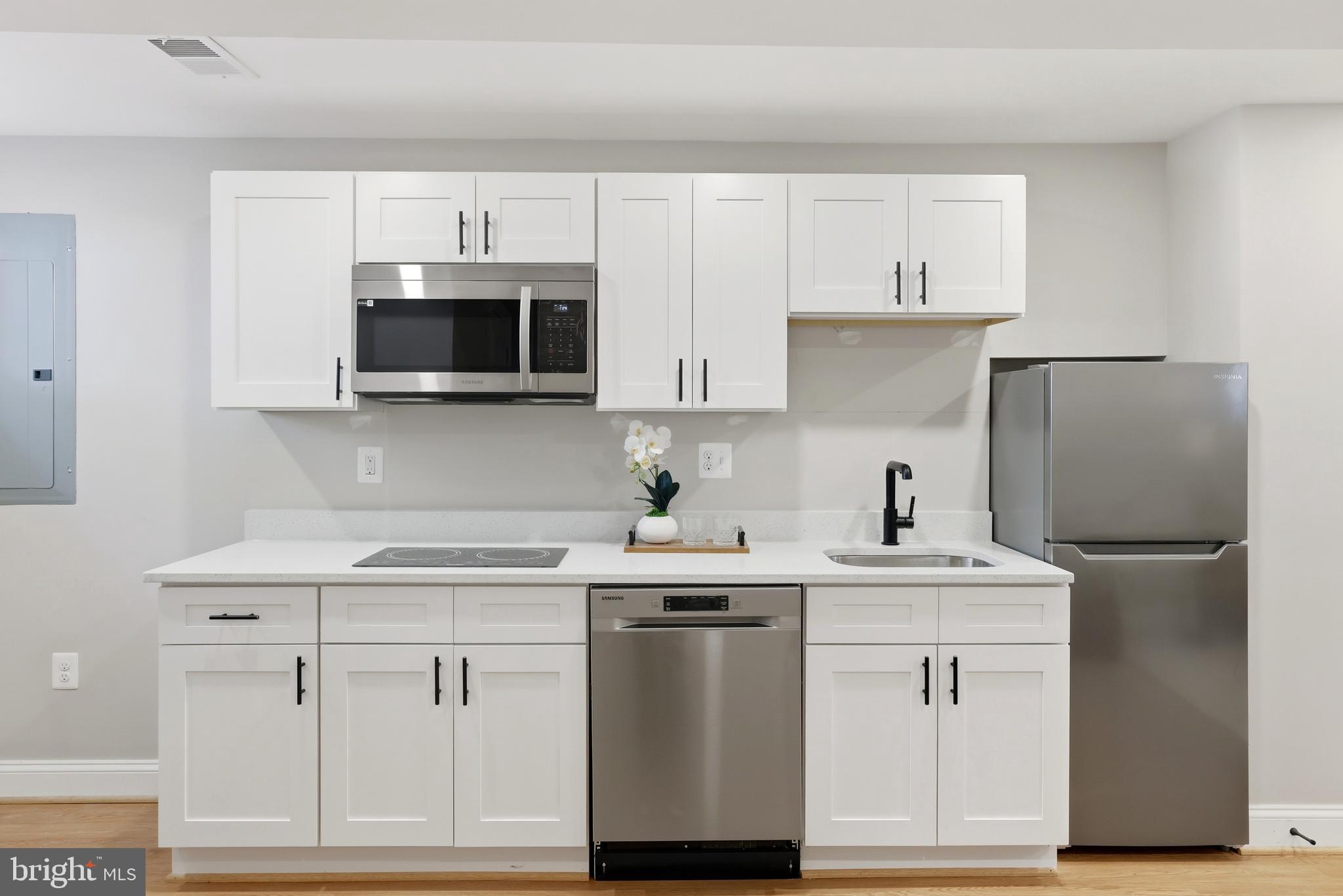 910 Westminster Street Northwest Washington, DC 20001 - Photo 46 of 66 a kitchen with white cabinets stainless steel appliances and sink