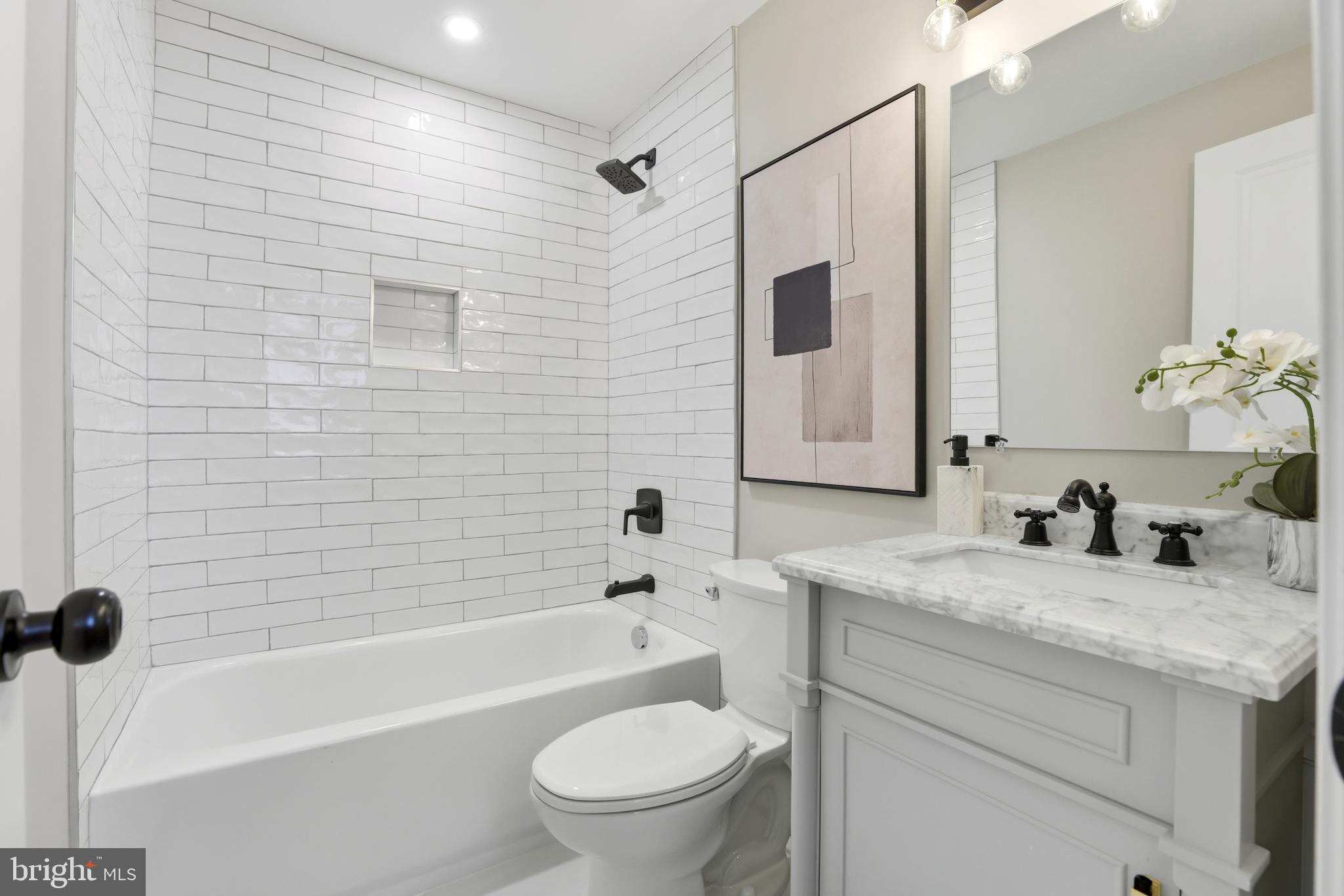 910 Westminster Street Northwest Washington, DC 20001 - Photo 53 of 66 a bathroom with a granite countertop sink toilet and shower