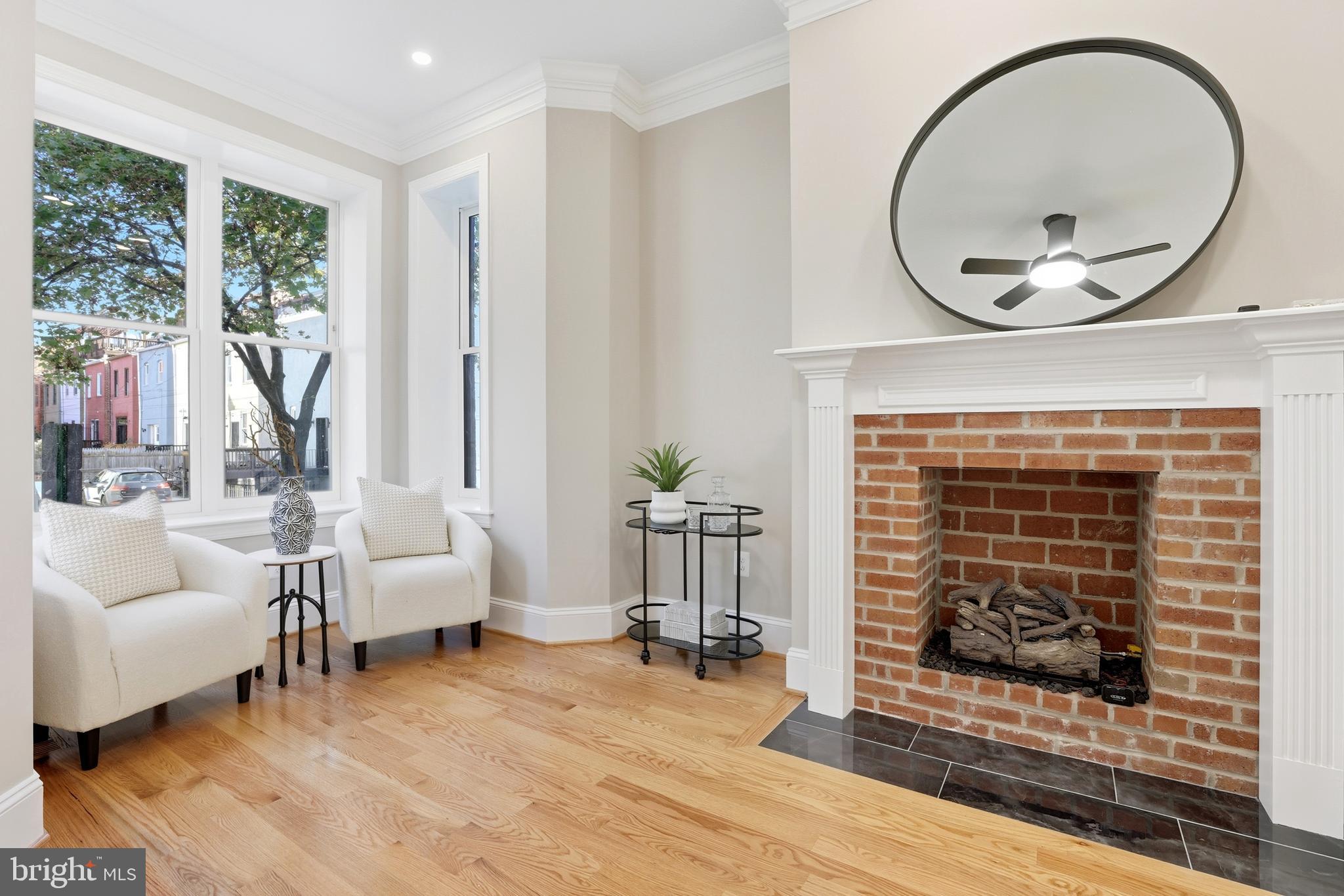 910 Westminster Street Northwest Washington, DC 20001 - Photo 6 of 66 a living room with furniture a fireplace and a floor to ceiling window