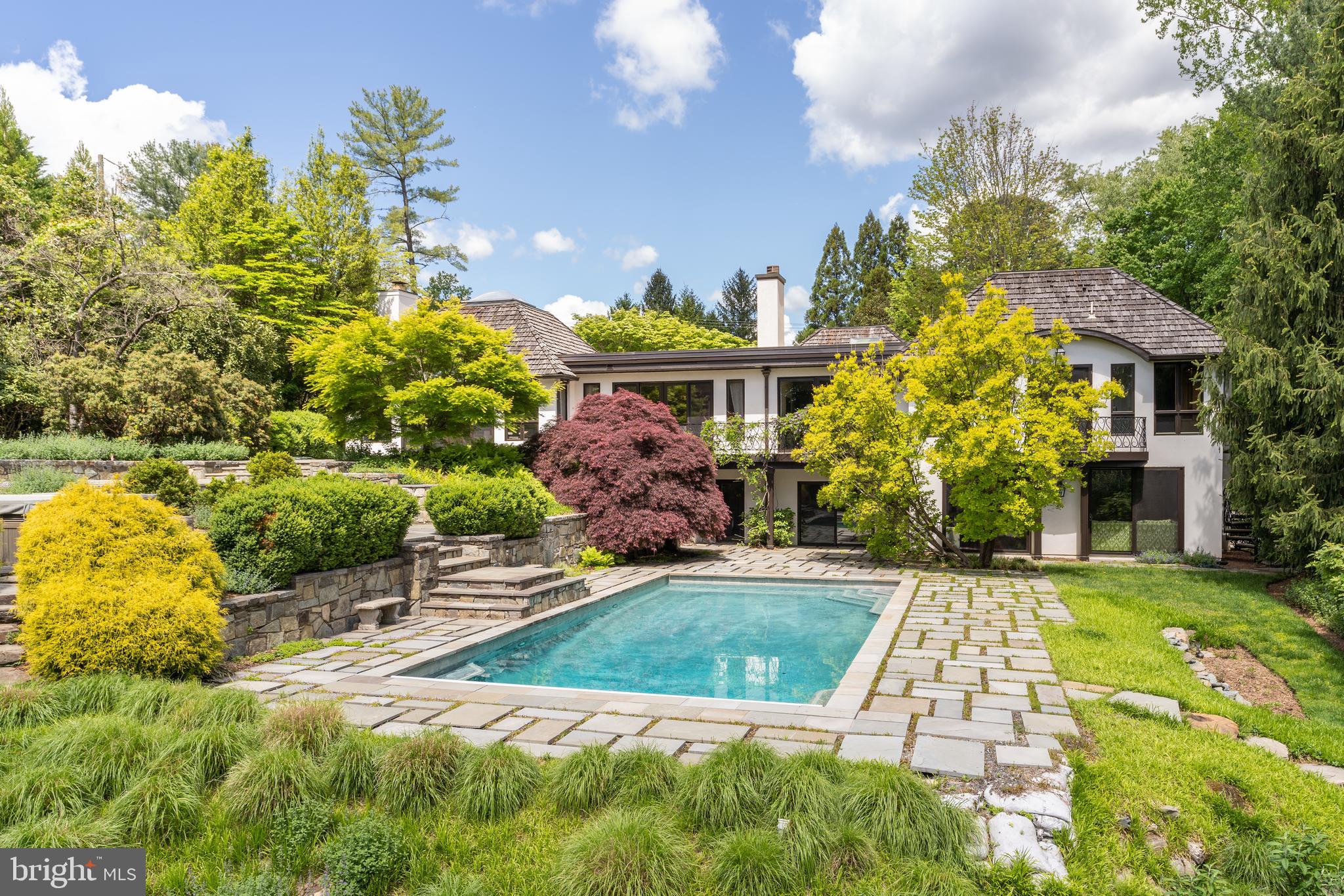 a view of a swimming pool with an outdoor seating and a yard