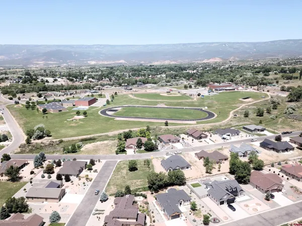 an aerial view of a house with yard